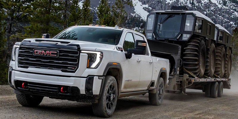 GMC Sierra 2500HD towing heavy equipment